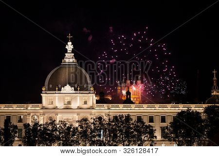 Lyon, France - July 14, 2019: Fireworks Bursting Over Hotel Dieu In Lyon For French National Holiday