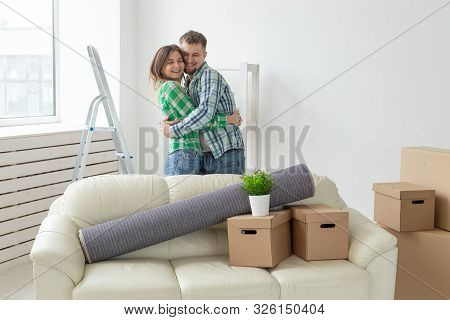 Relocation, Real Estate And Moving Concept - Young Cheerful Couple Moving Into Their New Home