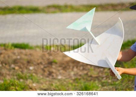 Unrecognizable Boy With Airplane Toy And His Parents