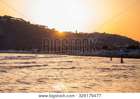Beautiful Sunset At Baja Beach, Showing The Procida Mountain, Naples, Campania, Italy