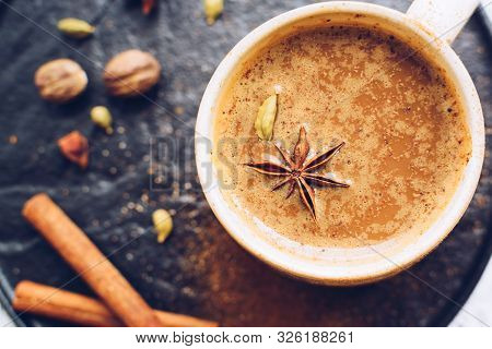 Coffee With Spices Over Black Plate. Beverage With Caffeine And Spices. Seasoning. Cinnamon. Badian.