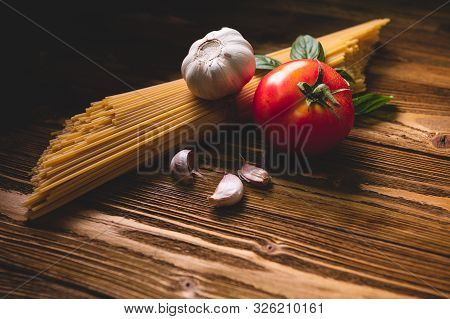 Tasty Appetizing Italian Spaghetti Pasta Ingredients For Kitchen Cuisine With Tomato, Garlic And Bas