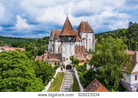 Aerial View Of Bazna Fortified Church. Saxon Landmark In Transylvania, Romania.