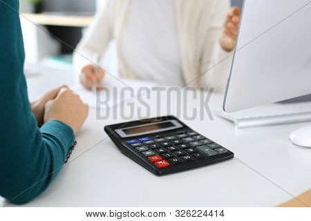 Accountant Checking Financial Statement Or Counting By Calculator Income For Tax Form, Hands Close-u