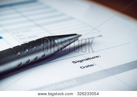 Close-up Of Silver Pen Are Signing The Contract Policy Agreement Papers. Legal Contract Signing.