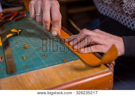 Professional Male Skinner, Tanner Working With Genuine Leather Belt At Workshop, Studio. Handmade An