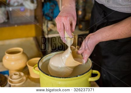Professional Male Potter Preparing Ceramic Wares For Burning In Pottery Kiln With Milk - Old Russian