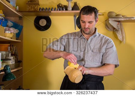 Professional Male Potter Preparing Ceramic Wares For Burning In Pottery Kiln With Milk - Old Russian