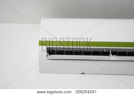 Air Conditioner Mounted On A White Wall In The Living Room Or Bedroom. Indooor Comfort Temperature. 