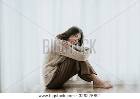 Sad Asian Woman With Depression Sitting Alone On The Floor. Major Depressive Disorder