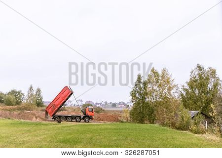 A Large 70-ton Dump Truck Brought Sand To A New Construction Site To Add Land