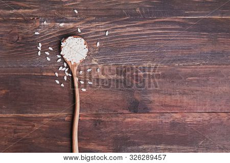 A Spoon With Carnaroli Or Arborio Rice On Wooden Background