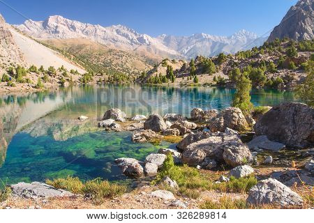 Amazing Mountain Landscape With Turquoise Lake In Fann Mountains, Tajikistan. Beautiful Summer Mount