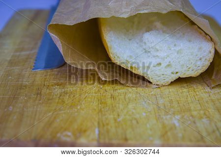 Fresh Baguette In A Paper Bag Closeup Copy Space.