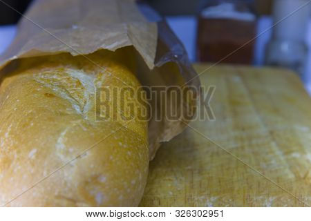 Fresh Baguette In A Paper Bag Closeup Copy Space.