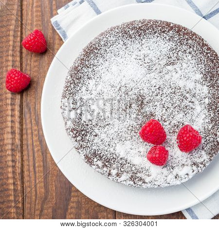 Chocolate Sticky Brownie Cake, Swedish Dessert Kladdkaka, On The Plate, Garnished With Icing Sugar A