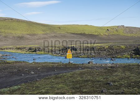 Iceland, South Highlands, August 1, 2019: Blue Glacier River Cross On Mountain Road F210 With Warnin