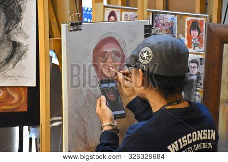 Bangkok, Thailand 08.23.2019: A Thai Artist Is Drawing A Realistic Portrait With Colored Pencils On 