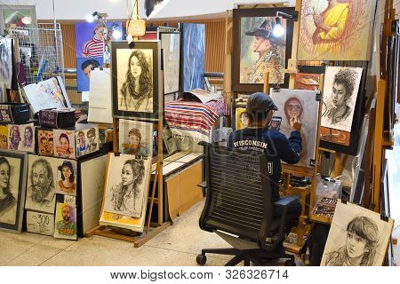 Bangkok, Thailand 08.23.2019: A Thai Artist Is Drawing A Realistic Portrait With Colored Pencils On 