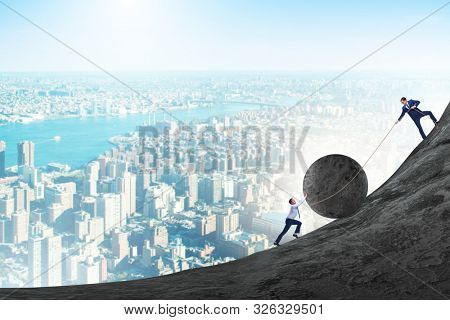 Teamwork example with business people pushing stone to top