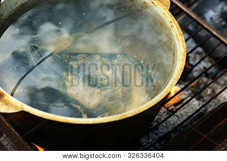 Fish Soup - Uha - With Grayling Cooked In Large Castiron Pot At Bonfire