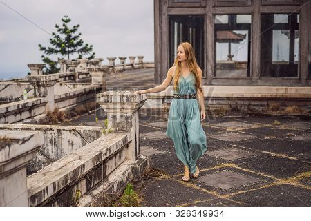 Woman Tourist In Abandoned And Mysterious Hotel In Bedugul. Indonesia, Bali Island. Bali Travel Conc