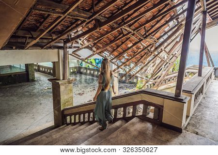 Woman Tourist In Abandoned And Mysterious Hotel In Bedugul. Indonesia, Bali Island. Bali Travel Conc