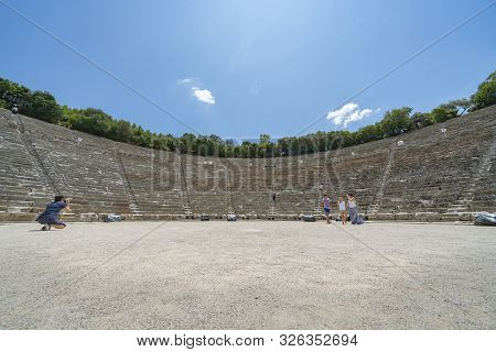 Epidaurus Greece - July 19 2019; Ancient Epidaurus Theatre Stone Seating Rows With Modern Numbers Ad
