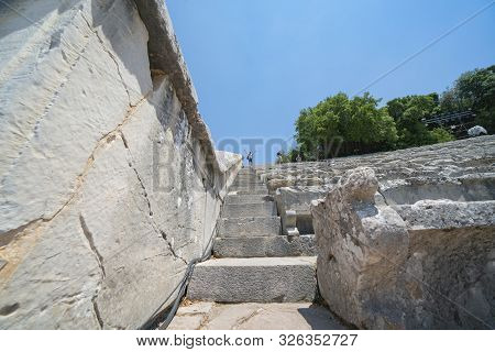 Epidaurus Greece - July 19 2019; Ancient Epidaurus Theatre Stone Seating Rows With Modern Numbers Ad