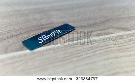 Close Up View Of Slim Fit Tag For Jeans.