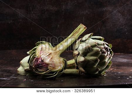 Artichokes On Rustic Dark Background. Fresh Organic Artichoke Flower.