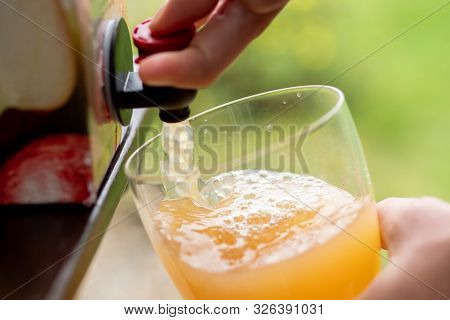 Vacuum Boxed Apple Juice Being Poured Into A Glass.