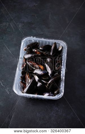 Fresh Uncooked Raw Big Mussels On Dark Background