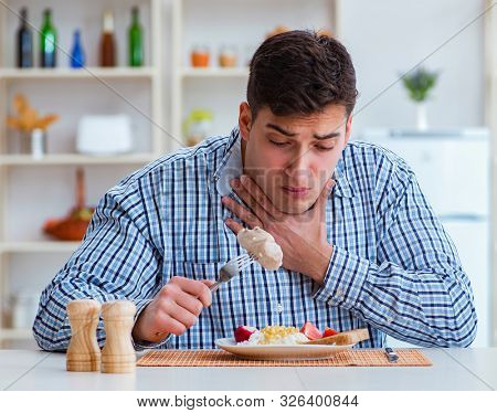 Man eating tasteless food at home for lunch
