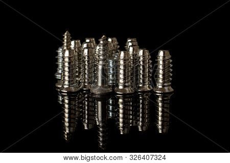 Lot Of Whole Metallic Glossy Bolt City Isolated On Black Glass