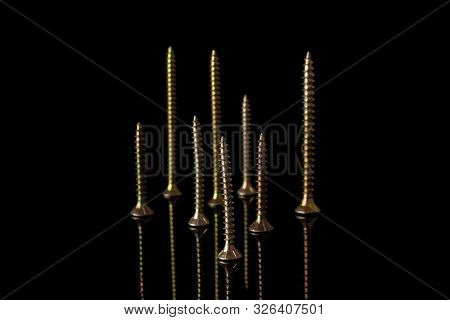 Group Of Eight Whole Metallic Glossy Bolt Isolated On Black Glass