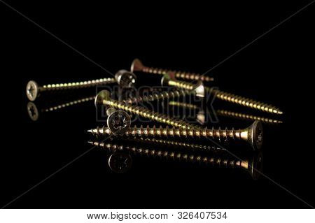 Group Of Eight Whole Metallic Glossy Bolt Isolated On Black Glass