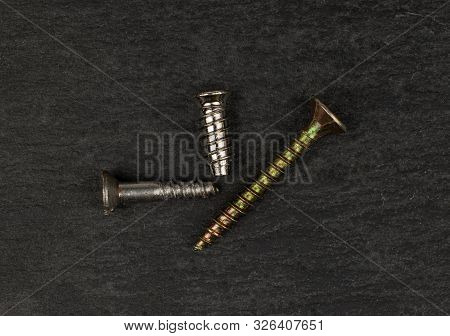 Group Of Three Whole Metallic Glossy Bolt Flatlay On Grey Stone