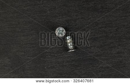Group Of Two Whole Glossy Metallic Glossy Bolt Flatlay On Grey Stone