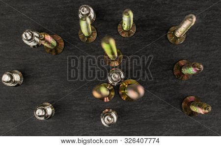 Group Of Fifteen Whole Metallic Glossy Bolt Flatlay On Grey Stone