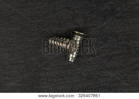 Group Of Two Whole Metallic Glossy Bolt Flatlay On Grey Stone