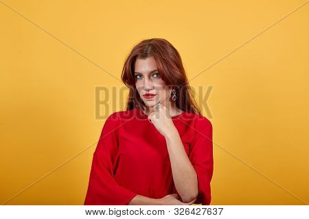 Peaceful Woman Propped Chin On Her Left Hand. This Gesture Shows That She Is Very Serious And Humorl