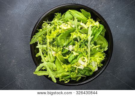 Green Salad Leaves Mix. Baby Spinach Leaves, Arugula And Frieze On Black Background. Top View.