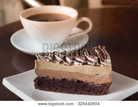 Slice Of Tiramisu Coffee Cake On A White Plate. Chose Up Of Coffee Chocolate Layer Cake.