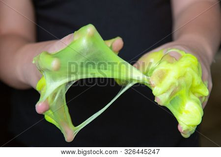 Kid Playing Handmade Toy Called Slime Green Color, Selective Focus On Slime, Teenager Having Fun And