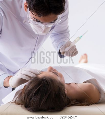Police coroner examining dead body corpse in morgue