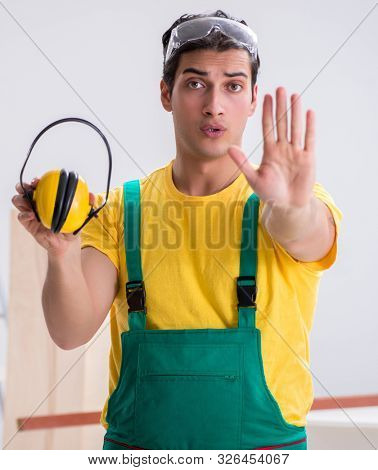 Worker showing the importnace of wearing noise cancelling headph