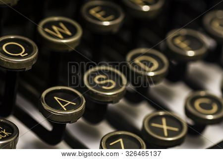 Close Up Of Black Antique Typerwriter Keyboard With Yellowing Letters. Shallow Dof