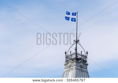 Quebec Flag At The Top Of The Quebec Parliament Building In Quebec City.