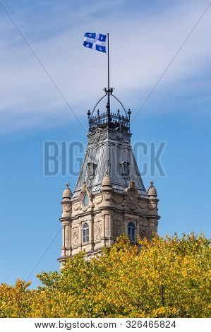 Quebec Flag At The Top Of The Quebec Parliament Building In Quebec City.